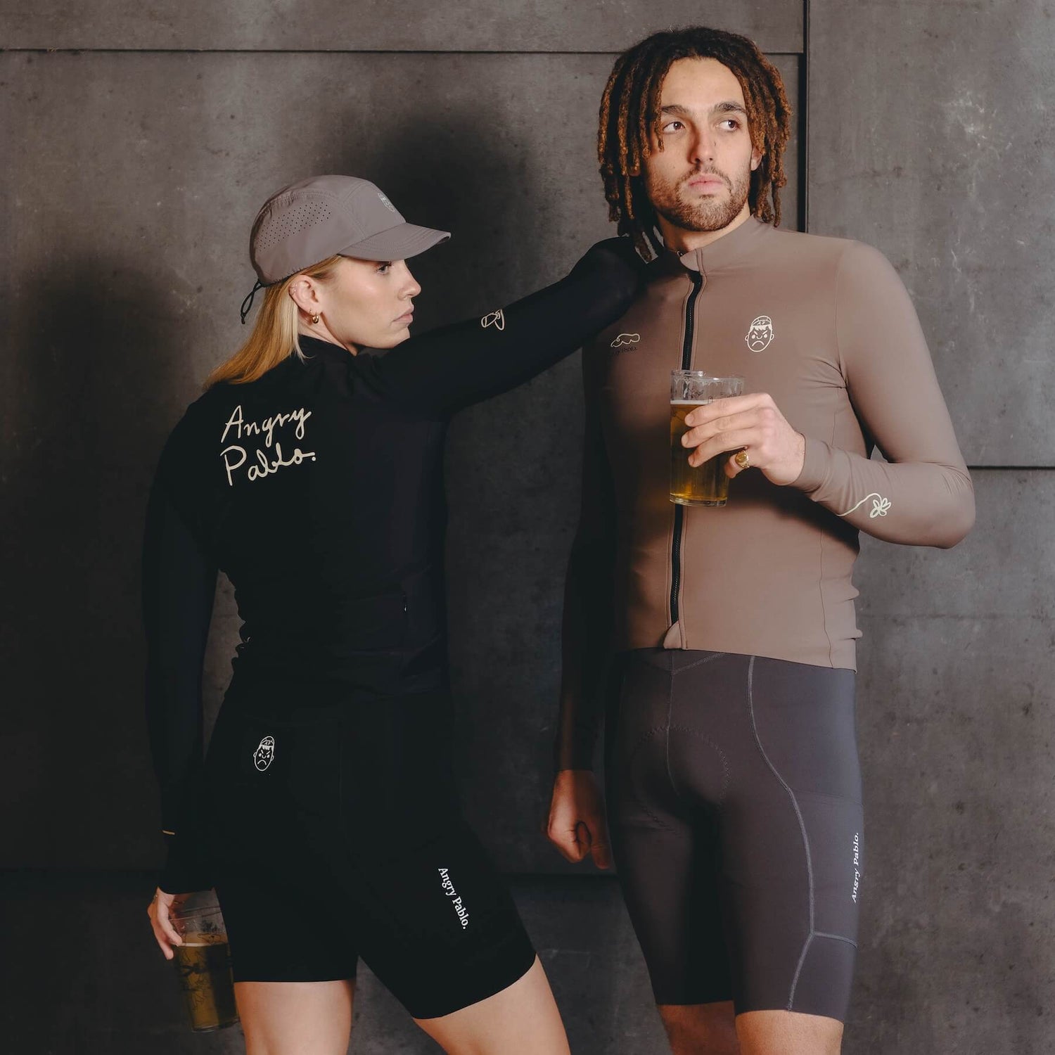 A male and female cyclist wearing angry pablo long sleeve cycling jerseys and bib shorts